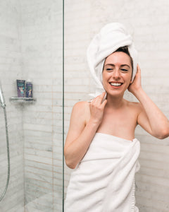 woman stepping out of shower in towel